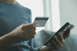 Close up of woman hand using credit card and laptop for payment and online shopping, Online shopping, payments digital banking, E-commerce concept. photo