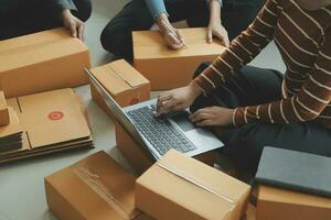 Business woman start up small business entrepreneur SME success .freelance woman working at home with Online Parcel delivery. SME and packaging deliveryconcept photo