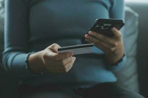 Close up of woman hand using credit card and laptop for payment and online shopping, Online shopping, payments digital banking, E-commerce concept. photo