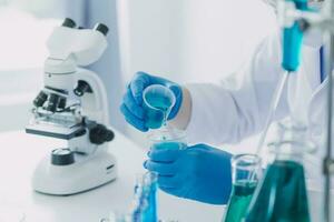 microscope with lab glassware, science laboratory research and development concept photo