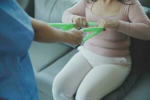 Doctor or physical therapist examines back pain and spinal area to give advice within the rehabilitation center. photo