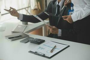 Group of confident business people point to graphs and charts to analyze market data, balance sheet, account, net profit to plan new sales strategies to increase production capacity. photo