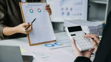 Financial analysts analyze business financial reports on a digital tablet planning investment project during a discussion at a meeting of corporate showing the results of their successful teamwork. photo