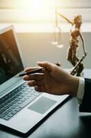 Business and lawyers discussing contract papers with brass scale on desk in office. Law, legal services, advice, justice and law concept picture with film grain effect photo