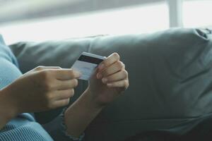 Close up of woman hand using credit card and laptop for payment and online shopping, Online shopping, payments digital banking, E-commerce concept. photo