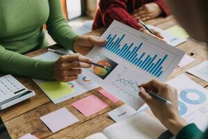 Financial analysts analyze business financial reports on a digital tablet planning investment project during a discussion at a meeting of corporate showing the results of their successful teamwork. photo