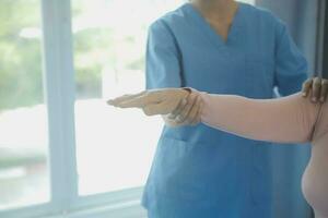 Doctor or physical therapist examines back pain and spinal area to give advice within the rehabilitation center. photo