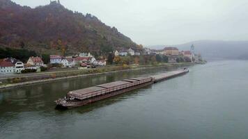 Cargo Pusher Boat on a River Transporting Cargo and Goods Past a Town video