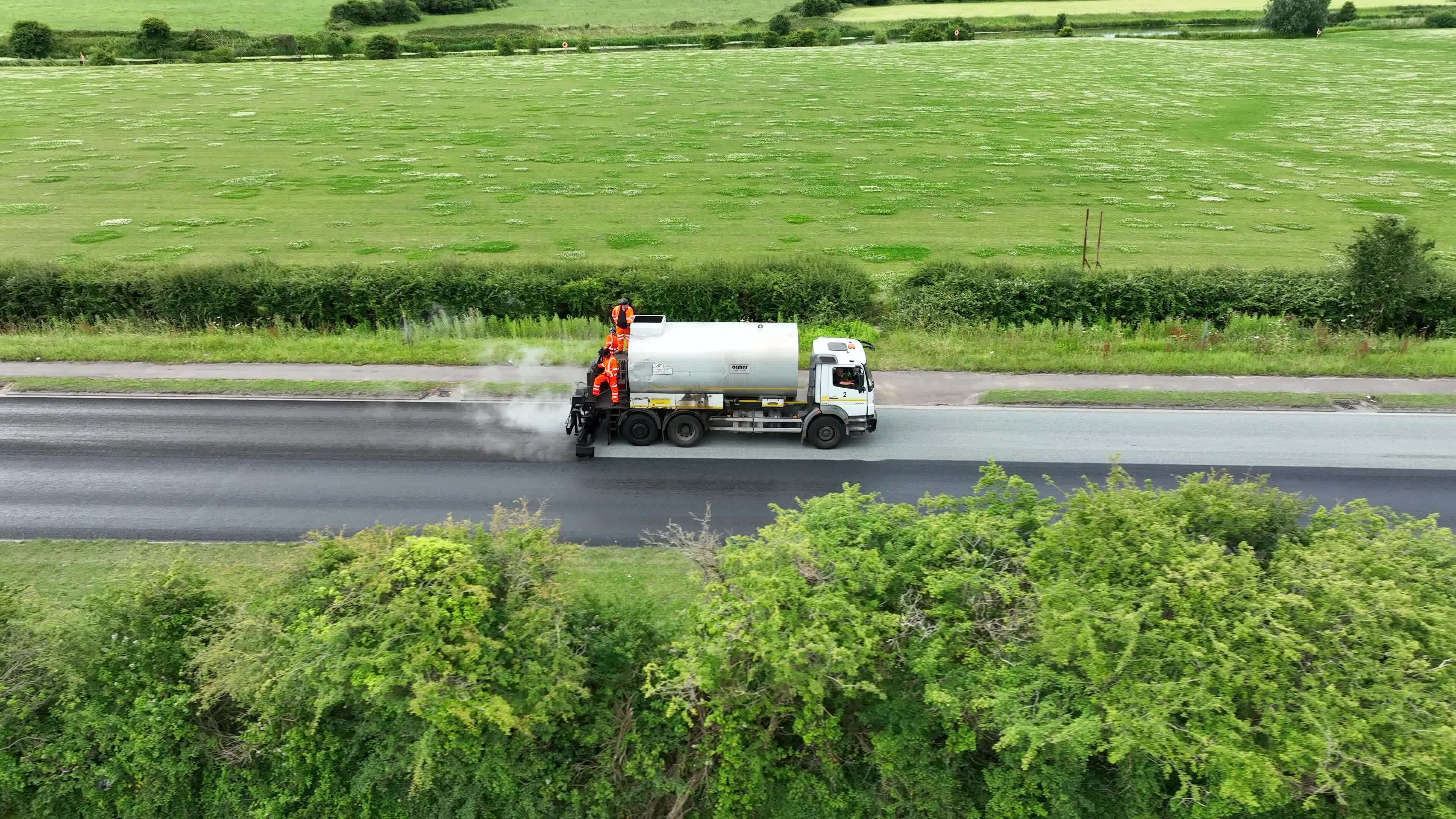 Road Resurfacing Using Micro Asphalt Surface Dressing 23450065 Stock road-resurfacing-using-micro-asphalt-surface-dressing-23450065-stock