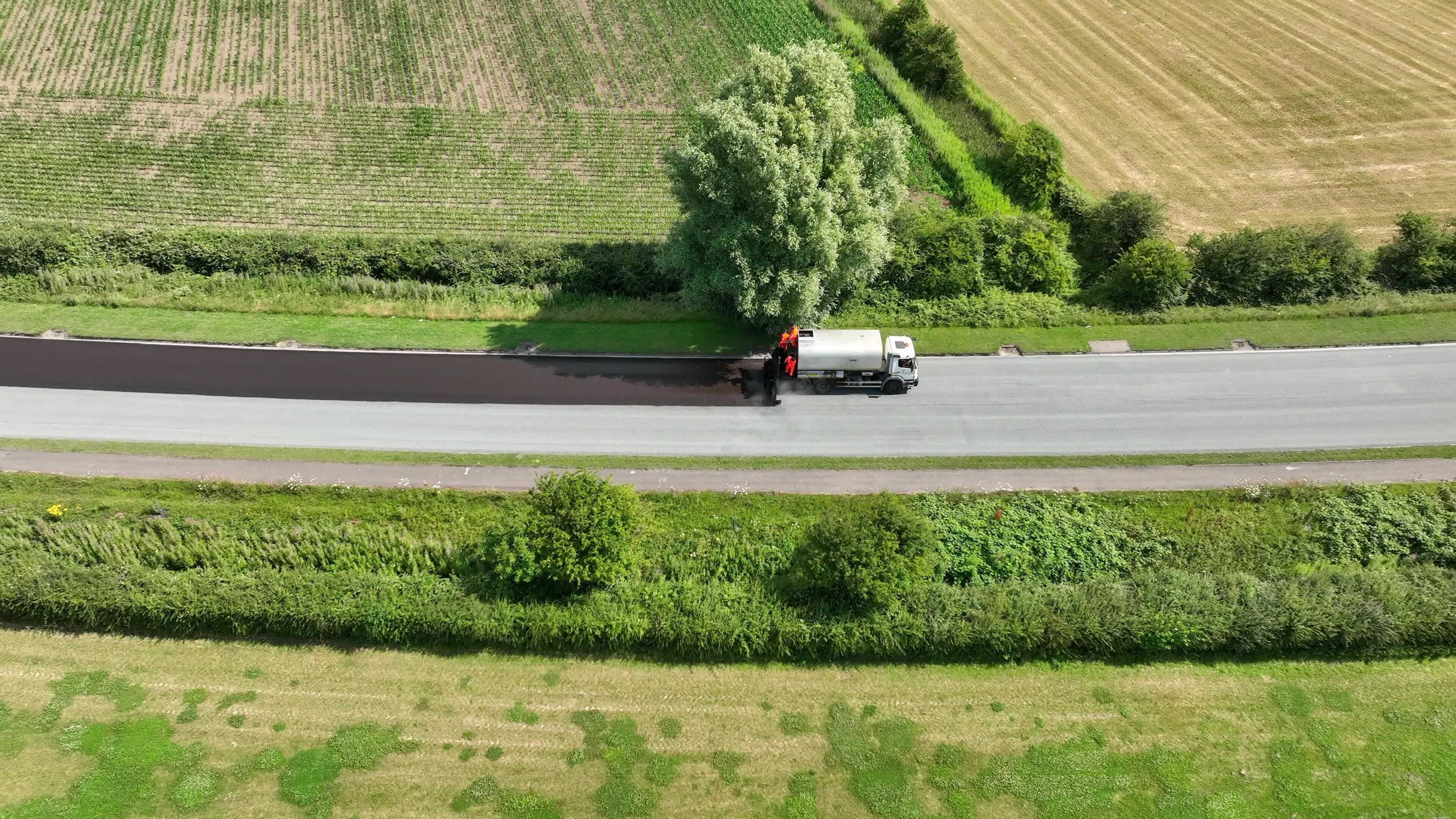 Road Resurfacing Aerial View Of Surface Dressing Micro Asphalt Process road-resurfacing-aerial-view-of-surface-dressing-micro-asphalt-process