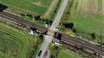 Cargo Train Passing Over a Level Crossing with Vehicles video