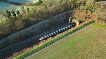 Train Carrying Commuters Speeding Through the Countryside Aerial View video