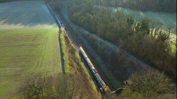 Train Carrying Commuters Speeding Through the Countryside Aerial View video