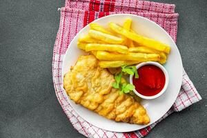 deep fried fish and chips french fries fast food  meal food snack on the table copy space food background rustic top view photo