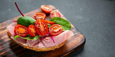 bruschetta ham sandwich tomato, lettuce snack meal food snack on the table copy space food background rustic top view photo