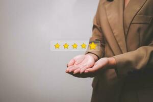 Customer pressing satisfaction with gold five star rating feedback icon and press level excellent rank for giving best score point to review the service , experience success business rate  concept. photo