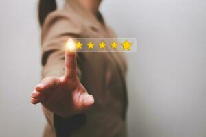 Customer pressing satisfaction with gold five star rating feedback icon and press level excellent rank for giving best score point to review the service , experience success business rate  concept. photo