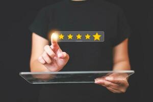 Customer pressing satisfaction with gold five star rating feedback icon and press level excellent rank for giving best score point to review the service , experience success business rate  concept. photo