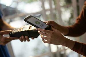 Female vase seller processes orders, including delivery payments, with smartphone and quick response code before sending items to customers. Small business owner work and coordinate with carrier. photo