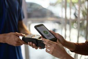 Female vase seller processes orders, including delivery payments, with smartphone and quick response code before sending items to customers. Small business owner work and coordinate with carrier. photo