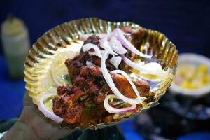 Chicken fry is served with Onion Salad at Zakaria Street During Eid photo