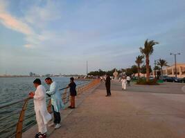 Jeddah, Saudi Arabia, April 2023 - Beautiful evening view of Jeddah Corniche. A large number of people are seen in the park of Jeddah Corniche. photo