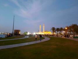 Jeddah, Saudi Arabia, April 2023 - Beautiful evening view of Jeddah Corniche. A large number of people are seen in the park of Jeddah Corniche. photo