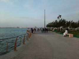 Jeddah, Saudi Arabia, April 2023 - Beautiful evening view of Jeddah Corniche. A large number of people are seen in the park of Jeddah Corniche. photo