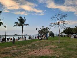 Jeddah, Saudi Arabia, April 2023 - Beautiful evening view of Jeddah Corniche. A large number of people are seen in the park of Jeddah Corniche. photo