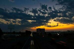 Sunset in the Queretaro city with a view of the highway and buildings photo