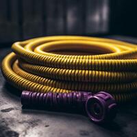 A purple and yellow hose is laying on table photo