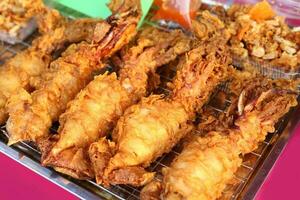 street market food deep fried squids photo