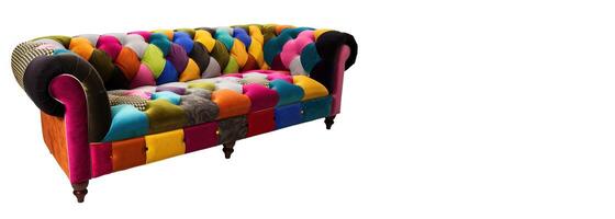 Chesterfield sofa from multi-colored fabric, patchwork, on a white background. . photo