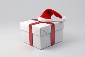 Christmas red gift box with ribbon and santa claus hat on gray background, isolate. . photo