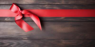 red ribbon on a wooden table photo