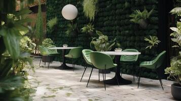 Cafe garden with modern green tropical plants, round glass coffee table with umbrella. photo