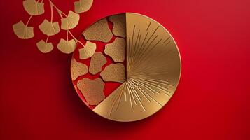 Shiny gold brass metal art, chinese style ginkgo leaf in circle outline, symbol of love and peace on bright red background. photo