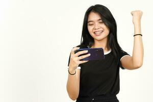 Smiling and Playing Mobile Game on Smartphone Of Beautiful Asian Woman Isolated On White Background photo