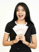 Holding 100000 Rupiah Banknote of Beautiful Asian Woman Isolated On White Background photo