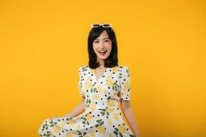 Portrait cheerful young asian woman happy smile dressing springtime female style fashion isolated on yellow background. attractive pretty model girl posing emotion summertime concept. photo