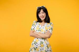 Portrait cheerful young asian woman happy smile dressing springtime female style fashion isolated on yellow background. attractive pretty model girl posing emotion summertime concept. photo