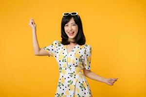 Portrait cheerful young asian woman happy smile dressing springtime female style fashion isolated on yellow background. attractive pretty model girl posing emotion summertime concept. photo