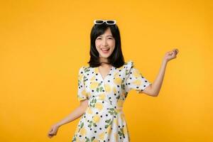 Portrait cheerful young asian woman happy smile dressing springtime female style fashion isolated on yellow background. attractive pretty model girl posing emotion summertime concept. photo