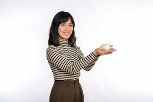 Portrait of young Asian woman casual uniform holding white piggy bank isolated on white background, Financial and bank saving money concept photo