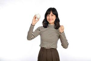 Portrait of young Asian woman casual uniform holding white piggy bank isolated on white background, Financial and bank saving money concept photo