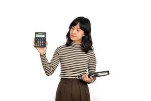 Portrait of young Asian woman casual uniform holding white piggy bank and notebook isolated on white background. Financial and bank saving money concept photo