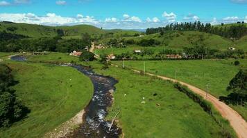 Water stream on rural village aerial view video