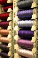 Multicolored Spools of Thread in a Vertical Stack photo