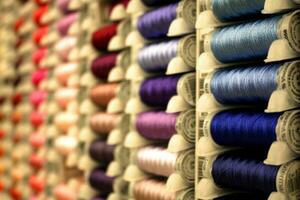 Vibrantly Colored Spools of Thread in a Horizontal Display photo