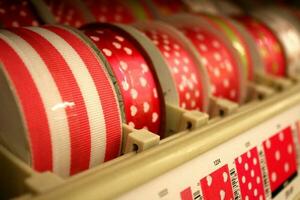 Spools of Red Patterned Ribbon on Display photo
